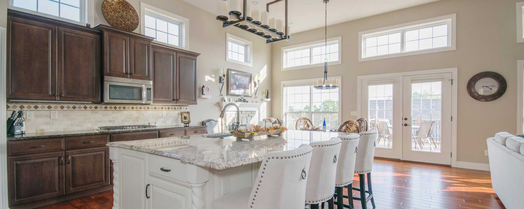 Sunny kitchen with white and brown cabinets